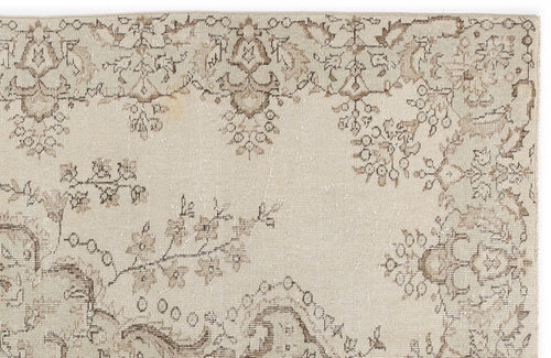 Load image 1 in gallery view. Beige and taupe vintage-style rug with a distressed floral medallion pattern on a white background.