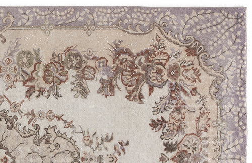 Load image 1 in gallery view. Beige and lavender traditional rug with a distressed floral medallion pattern and ornate border.