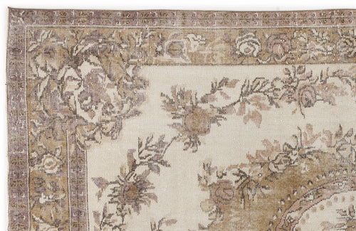 Load image 1 in gallery view. Distressed beige and mauve floral area rug with a traditional border pattern on a white background.