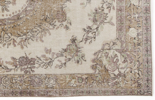 Load image 1 in gallery view. Beige and taupe vintage-style rug with a distressed floral medallion pattern and a decorative border.