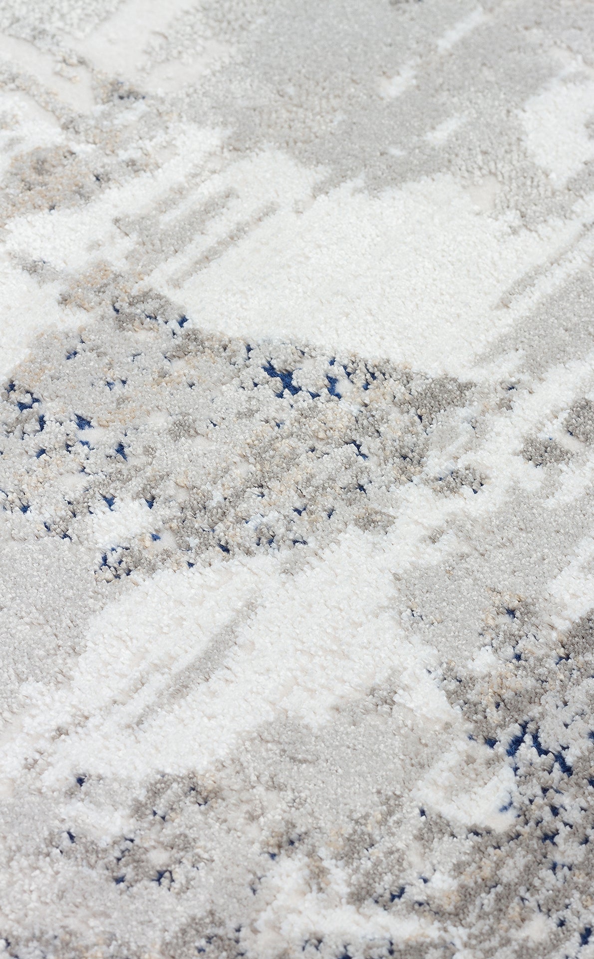 White, grey, and navy blue abstract distressed pattern with a high-pile textured finish.