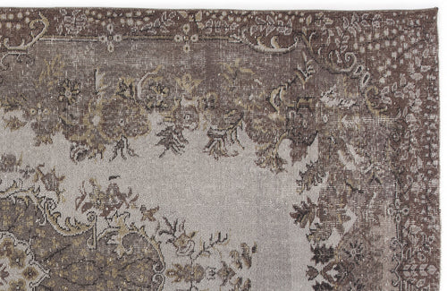Load image 1 in gallery view. Distressed brown and grey rug with a faded traditional floral medallion pattern on a white background.