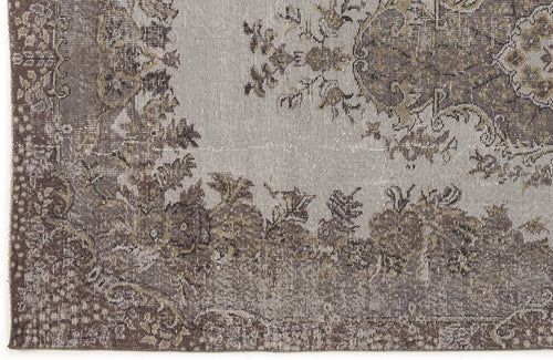 Load image 1 in gallery view. Grey and brown distressed rug with a traditional floral medallion pattern and ornate border.