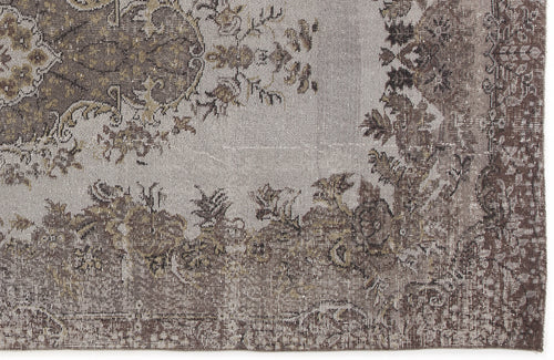 Load image 1 in gallery view. Grey and brown distressed rug with a traditional floral medallion pattern and ornate border.