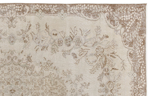 Load image 1 in gallery view. Beige and taupe traditional rug with a distressed floral medallion pattern on a white background.