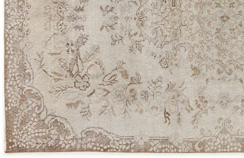 Load image 1 in gallery view. Beige and taupe distressed rug with a traditional floral medallion pattern and ornate border.
