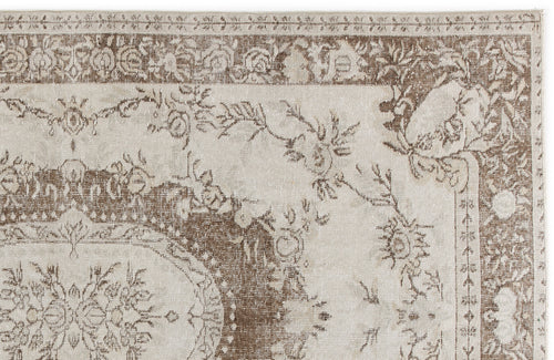 Load image 1 in gallery view. Beige and brown traditional rug with a distressed floral medallion pattern and ornate border.