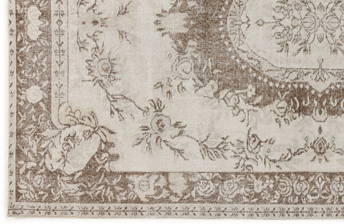 Load image 1 in gallery view. Beige and brown traditional rug with a distressed floral medallion pattern and ornate border.