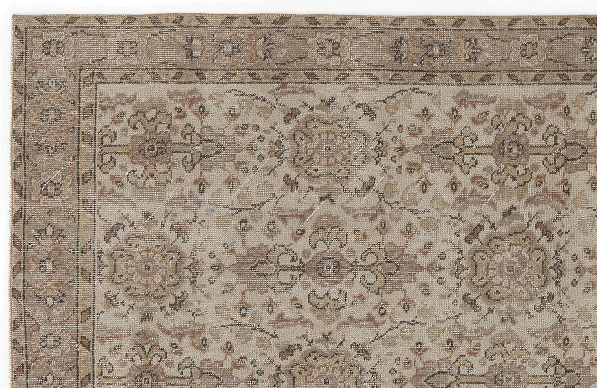 Beige and taupe traditional rug with a distressed floral medallion pattern and a decorative border.