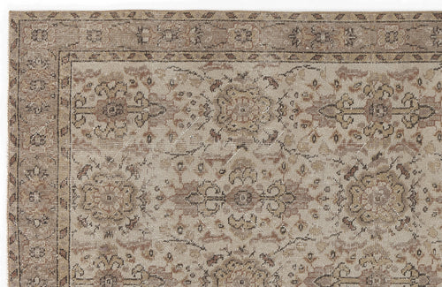 Load image 1 in gallery view. Beige and taupe traditional rug with a distressed floral medallion pattern and a decorative border.