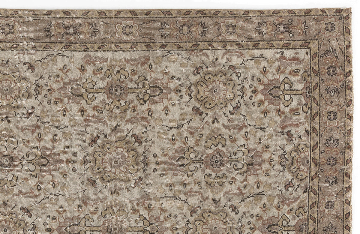 Beige and brown traditional rug with a distressed floral medallion pattern and a decorative border.