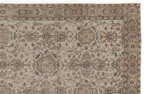 Load image 1 in gallery view. Beige and brown traditional rug with a distressed floral medallion pattern and a decorative border.