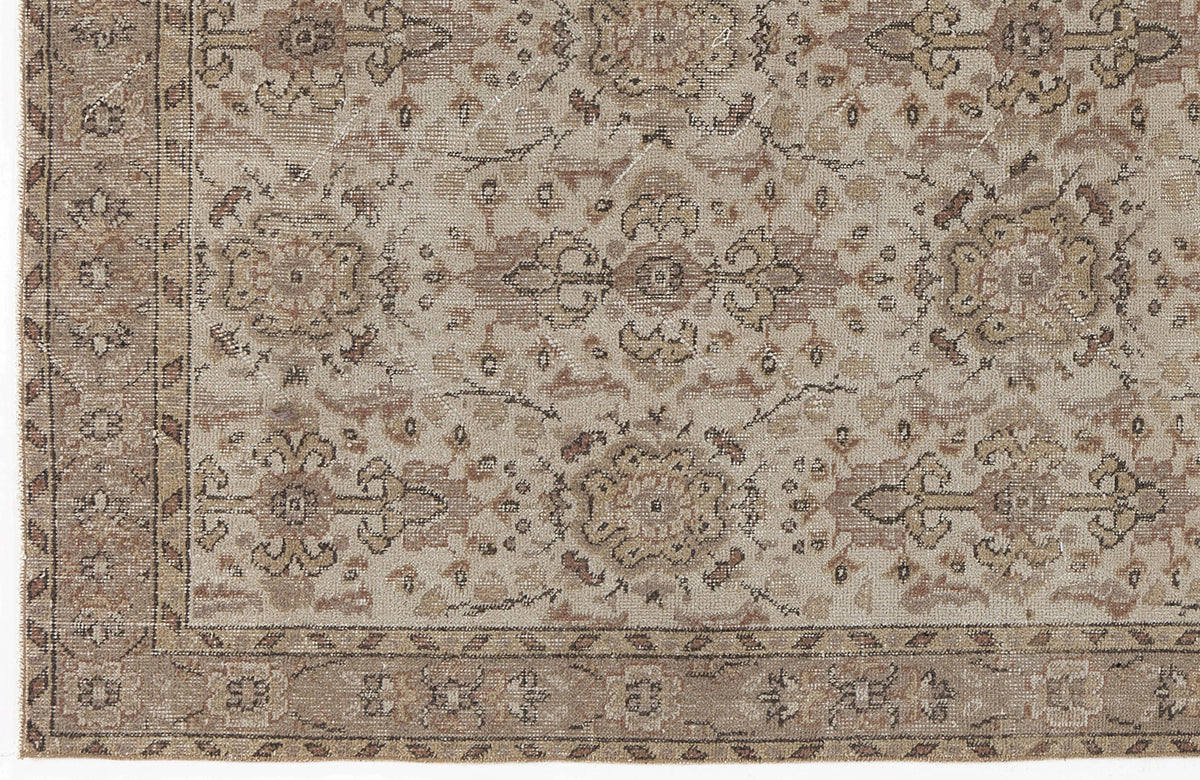 Beige and taupe traditional rug with a distressed floral medallion pattern and a decorative border.