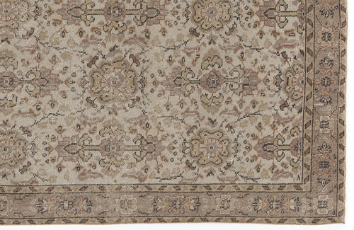 Load image 1 in gallery view. Beige and brown vintage-style rug with a distressed floral medallion pattern and a decorative border.