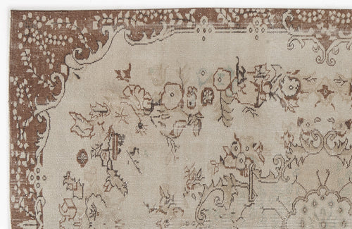 Load image 1 in gallery view. Beige and brown vintage-style rug with a distressed floral medallion pattern and ornate border.