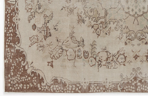 Load image 1 in gallery view. Beige and brown distressed rug with a faded floral medallion pattern and ornate border.