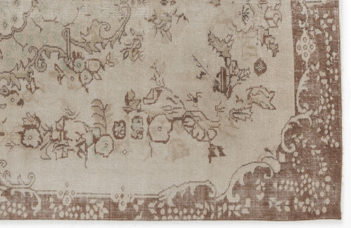 Load image 1 in gallery view. Beige and brown distressed rug with a faded floral medallion pattern and a wide decorative border.
