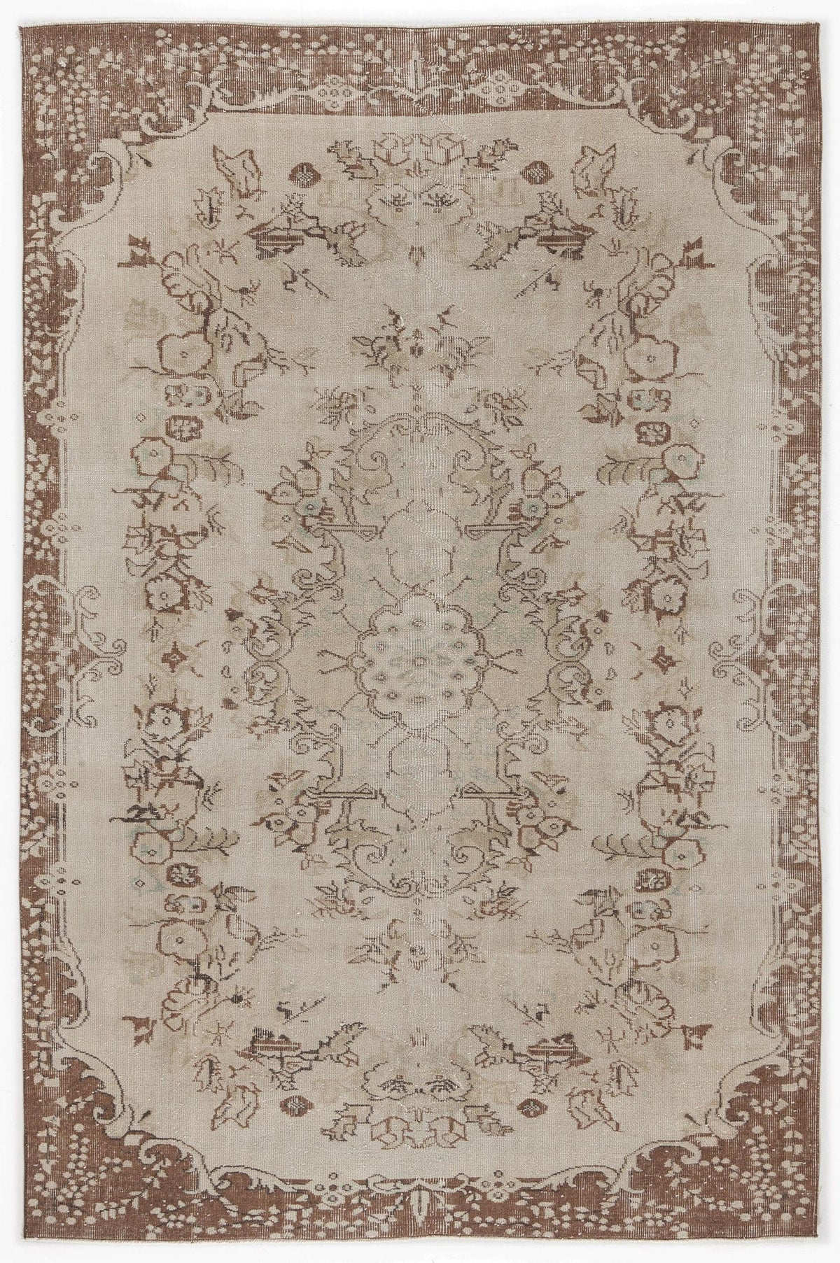 Beige and brown vintage-style rug with a central floral medallion and a decorative border on a white background.