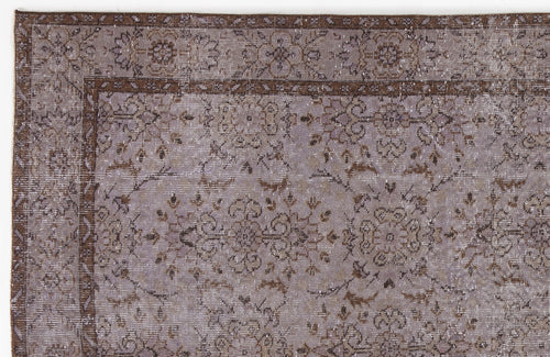 Load image 1 in gallery view. Distressed lavender and brown rug with a traditional floral medallion pattern and a decorative border.