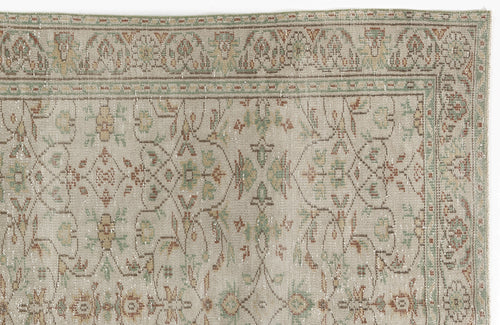 Load image 1 in gallery view. Beige rug with a distressed traditional floral pattern in muted sage green, terracotta, and gold.