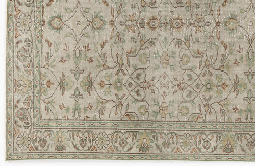 Load image 1 in gallery view. Beige rug with a distressed traditional floral medallion pattern in muted green, brown, and cream tones.