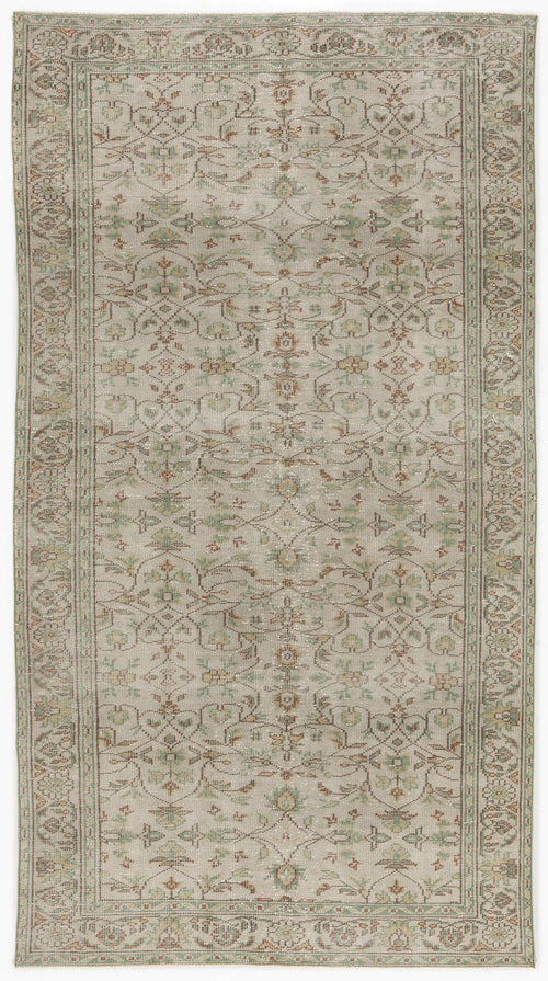 Load image 1 in gallery view. Beige traditional rug with a distressed floral medallion pattern in muted green and rust tones, isolated on white.