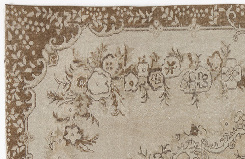 Load image 1 in gallery view. Beige and brown rug with a distressed floral pattern and a decorative border.