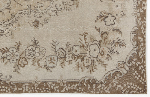 Load image 1 in gallery view. Beige and brown rug with a distressed floral pattern and a decorative border.