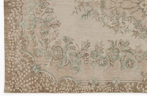 Load image 1 in gallery view. Beige and brown traditional rug with a distressed floral medallion pattern and soft sage green accents.