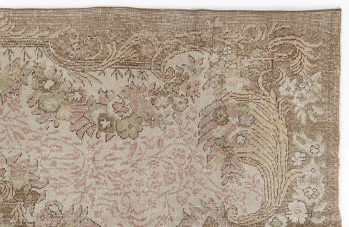 Load image 1 in gallery view. Distressed beige and brown rug with a faded floral medallion pattern and muted pink and sage green accents.