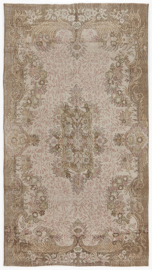 Load image 1 in gallery view. Distressed beige and pink traditional rug with a central floral medallion and ornate botanical border.
