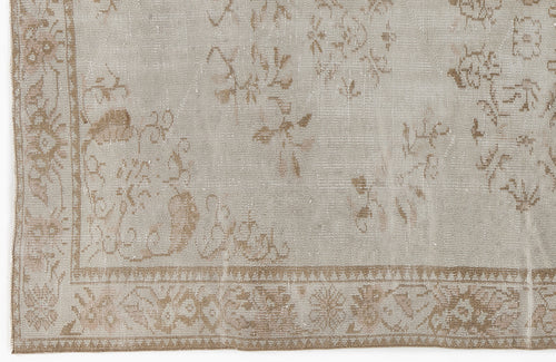 Load image 1 in gallery view. Beige and taupe distressed rug with a faded traditional floral pattern and a decorative border.