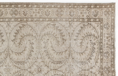 Load image 1 in gallery view. Beige and taupe vintage-style rug with a distressed floral vine pattern and a decorative geometric border.