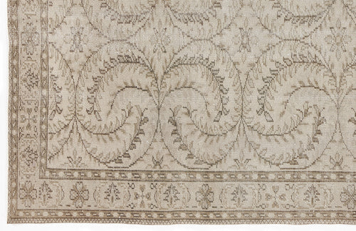 Load image 1 in gallery view. Beige and taupe traditional rug with a repeating vine and floral medallion pattern and a decorative border.