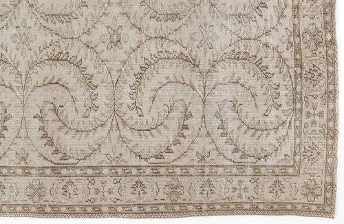 Load image 1 in gallery view. Beige and taupe rug with a repeating vine and floral medallion pattern and a decorative border.