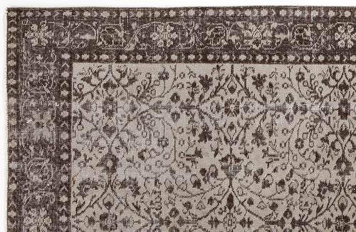 Load image 1 in gallery view. Dark brown and beige vintage-style rug with a distressed floral medallion pattern and a wide decorative border.