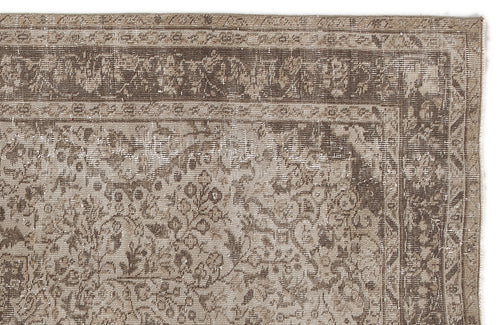 Load image 1 in gallery view. Distressed brown and beige vintage-style rug with a traditional floral medallion border and intricate central pattern.
