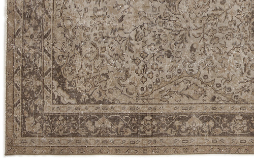 Load image 1 in gallery view. Distressed brown and beige rug with a traditional floral medallion pattern and a detailed geometric border.