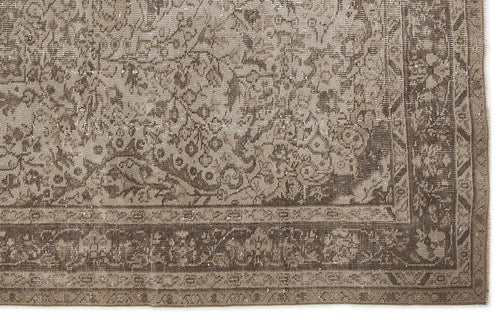 Load image 1 in gallery view. Taupe and brown vintage-style rug with a distressed floral medallion pattern and a detailed border.
