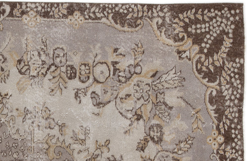Load image 1 in gallery view. Brown and grey vintage-style rug with a distressed floral medallion pattern and ornate border.