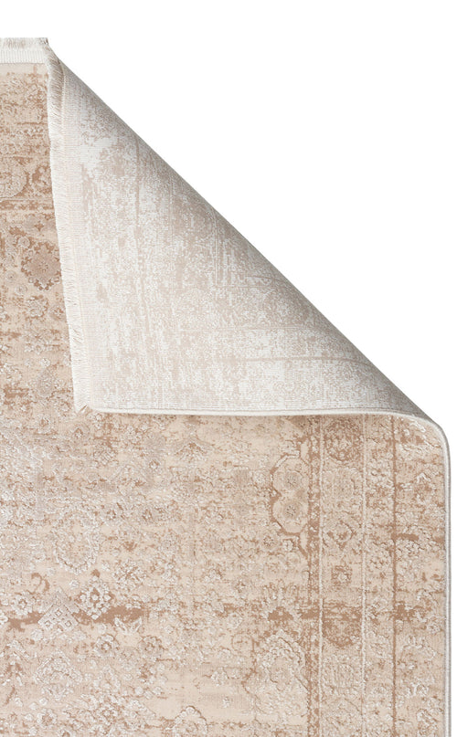 Bild 1 in Galerieansicht laden. Beige and cream traditional medallion rug with a distressed finish, shown with a corner folded over on a white background.