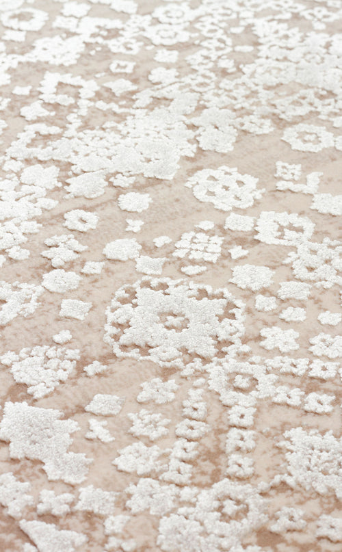 Bild 1 in Galerieansicht laden. Beige rug with a raised white floral medallion pattern and a high-low texture.