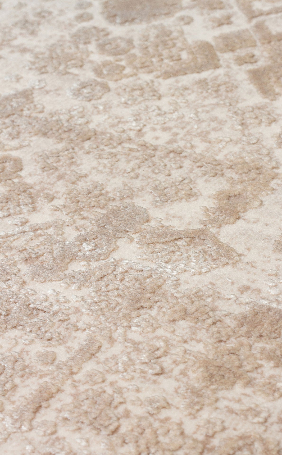 Beige and cream rug with a distressed, low-pile traditional medallion pattern.
