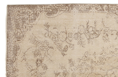 Load image 1 in gallery view. Beige and brown rug with a faded, distressed floral medallion pattern on a white background.