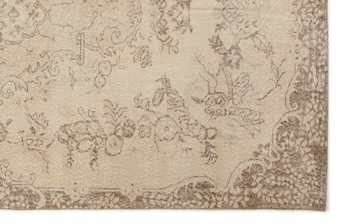 Load image 1 in gallery view. Beige and brown rug with a faded, distressed floral pattern and a decorative border.