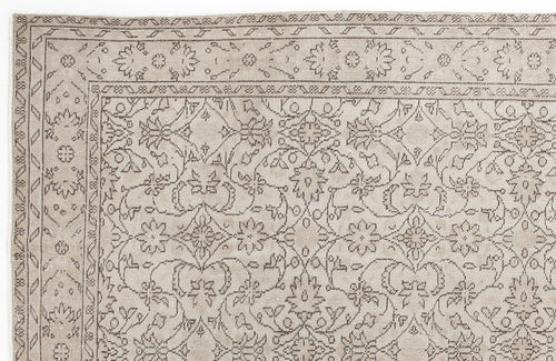 Load image 1 in gallery view. Beige and taupe traditional rug with a detailed floral vine pattern and a geometric border.