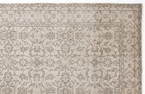 Load image 1 in gallery view. Beige rug with a dark brown traditional floral medallion pattern and a decorative geometric border.