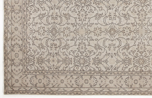 Load image 1 in gallery view. Beige rug with a dark brown traditional floral vine and medallion pattern and a decorative border.
