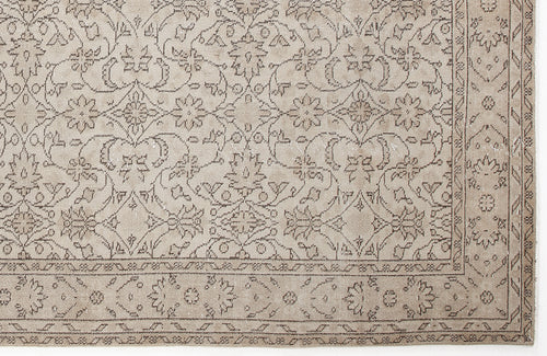 Load image 1 in gallery view. Beige rug with a dark brown traditional floral medallion pattern and a decorative border.