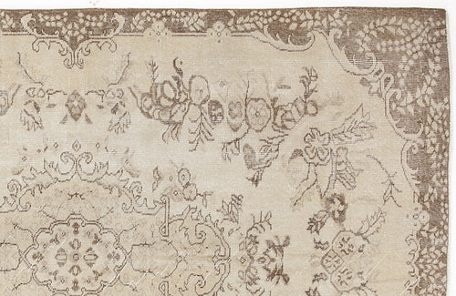 Load image 1 in gallery view. Beige and brown traditional rug with a distressed floral medallion pattern on a white background.